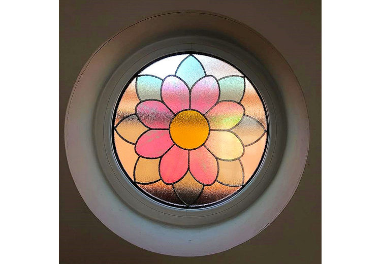 Circular aluminium feature stained and leaded window